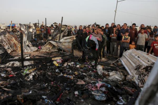 Palestinians look at the destruction after an Israeli strike wher<em></em>e displaced people were staying in Rafah, Gaza Strip, Monday, May 27, 2024. 