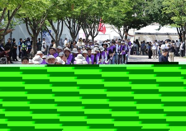 Officials from a group of bereaved families of the 2022 Itaewon crowd crush victims and a civic group march down a street in central Seoul on June 16, 2024, as they change the location of a memorial altar for the victims. (Yonhap)