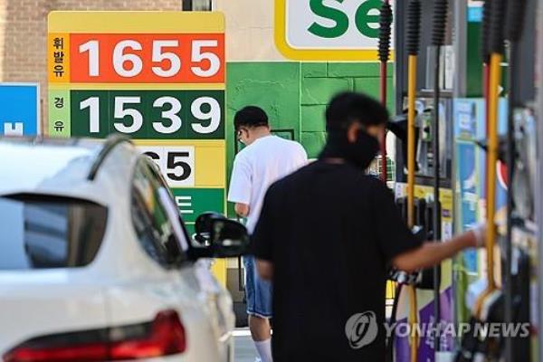 A man fills up his car with fuel at a gas station in Seoul on June 16, 2024. (Yonhap)