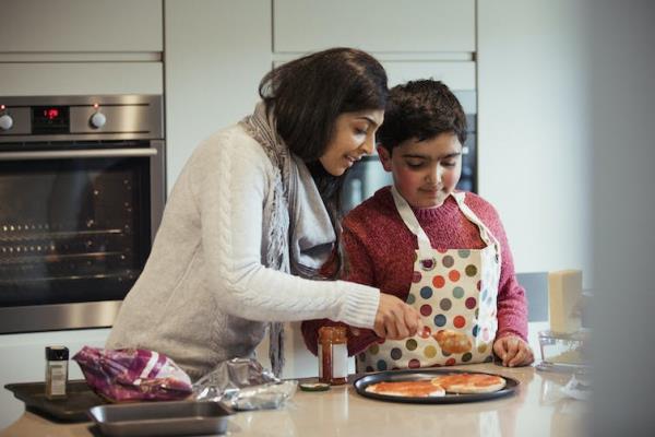 Mother helps her autistic son cook