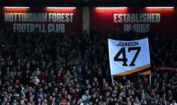 Fans hold aloft a tribute to Adam Johnson, the Nottingham Panthers Ice Hockey player who died after his throat was cut by an ice skate blade during a game, during the English Premier League football match between Nottingham Forest and Aston Villa at The City Ground in Nottingham, central England, on November 5, 2023. (Paul ELLIS / AFP)