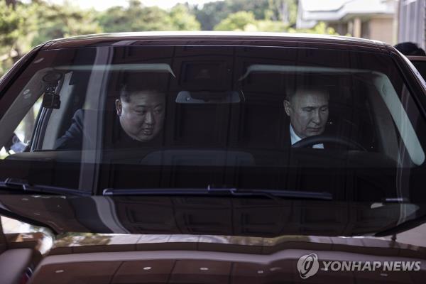 This photo, released by EPA and Sputnik, shows Russian President Vladimir Putin (R) and North Korean leader Kim Jong-un riding an Aurus car in Pyongyang, on June 19, 2024. (Pool photo) (Yonhap)